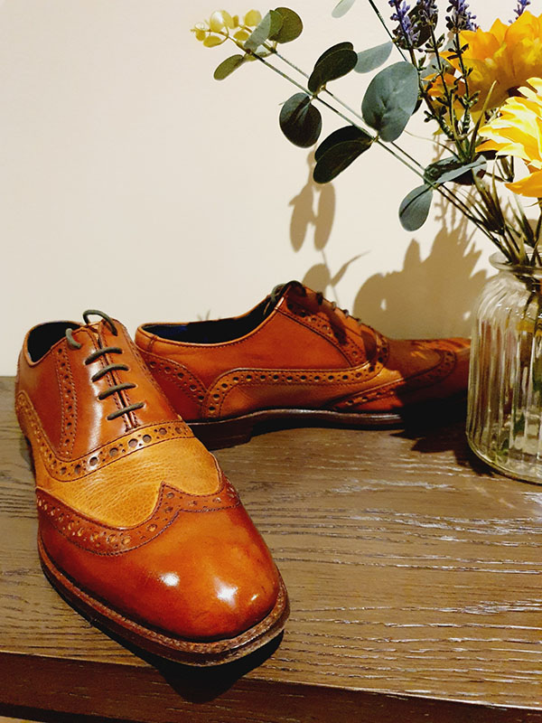 Pair of brown Barker spectator shoes after a shoeshine